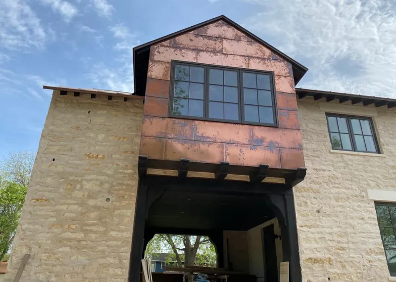 Copper metal panel facade on a stone building for Skylight Installation in Hanahan